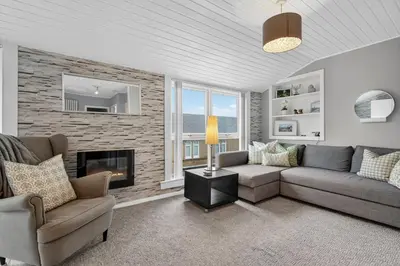 a living room with a couch and a fireplace at Coastal Charm: Modern Retreat by Seafront in Largs