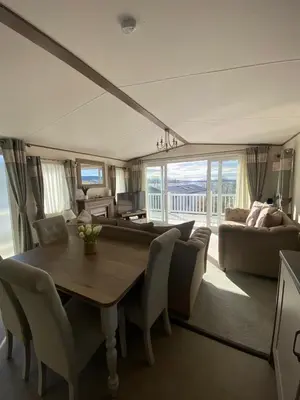 a living room with a wooden table and chairs at Wemyss Bay Beaumont Elite in Skelmorlie