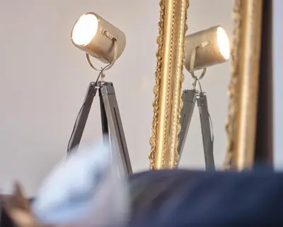 a light on a tripod in front of a mirror at Bruce on the Row-Historic Elegance near Edinburgh by Urban Haggis Stays in Dunfermline