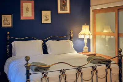 a bedroom with a bed and a blue wall at Bruce on the Row-Historic Elegance near Edinburgh by Urban Haggis Stays in Dunfermline