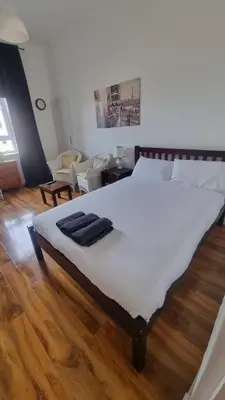 a bedroom with a large bed with two towels on it at City Centre Studio - Charing Cross in Glasgow