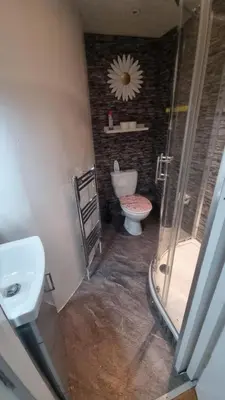a bathroom with a toilet and a glass shower at City Centre Studio - Charing Cross in Glasgow