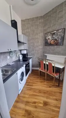 a kitchen with a sink and a table with chairs at City Centre Studio - Charing Cross in Glasgow