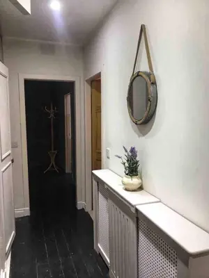 a hallway with a mirror on the wall and a counter at Close to beaches and golf courses in Maybole