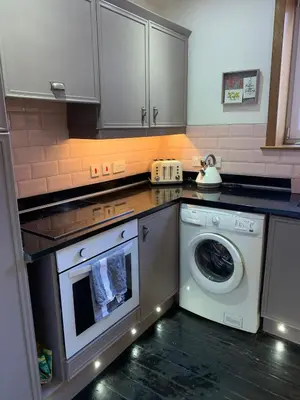 a kitchen with a washing machine and a washer at Close to beaches and golf courses in Maybole