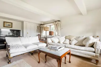 a living room with two white couches and a coffee table at Woodlea Cottage in Moffat