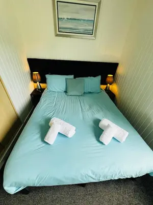 a bed with two towels on top of it at Tigh Na Sealladh in Dunoon