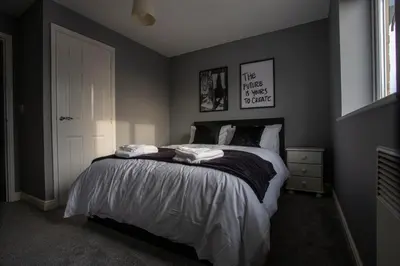 a bedroom with a bed with two towels on it at Modern 2-Bed Flat, Sleeps 6, Near Gosforth in Moffat