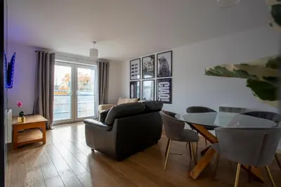 a living room with a couch and a glass table at Modern 2-Bed Flat, Sleeps 6, Near Gosforth in Moffat