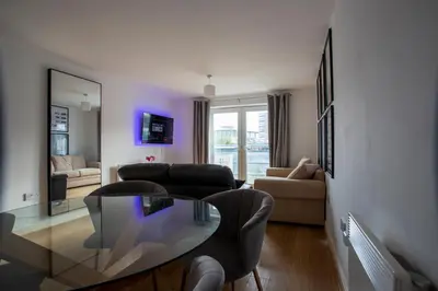 a living room with a glass table and a couch at Modern 2-Bed Flat, Sleeps 6, Near Gosforth in Moffat