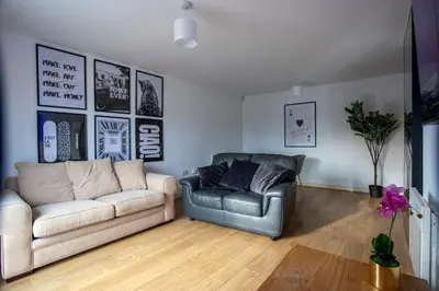 a living room with a couch and a chair at Modern 2-Bed Flat, Sleeps 6, Near Gosforth in Moffat
