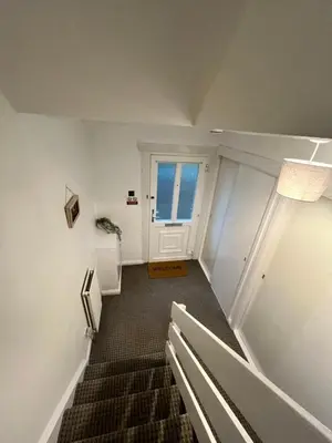 a stairway with a white door and a window at 100 Castle in New Cumnock