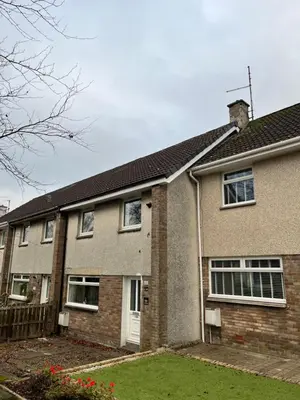 a brick house with a white door at 100 Castle in New Cumnock