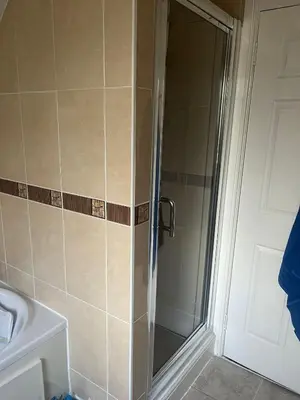 a shower with a glass door in a bathroom at Rowan in Bellshill