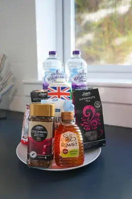a plate with a bunch of food and water bottles at Train House in Dunfermline