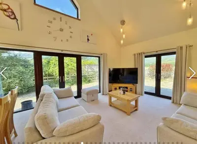 a living room with two couches and a tv at Sealladh Mor-Cottage in Lamlash, Arran in Lamlash
