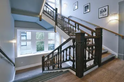 a staircase in a home with blue ceilings and a window at For Students Only - The Ballet School in Glasgow in Glasgow