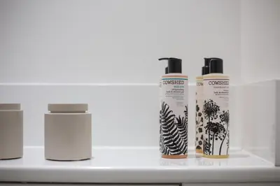 a group of three bottles of hair products on a shelf at For Students Only - The Ballet School in Glasgow in Glasgow