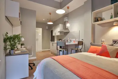a bedroom with a bed and a kitchen in it at For Students Only - The Ballet School in Glasgow in Glasgow