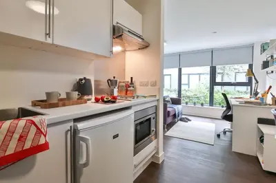 a kitchen with white cabinets and a counter top at For Students Only - The Ballet School in Glasgow in Glasgow