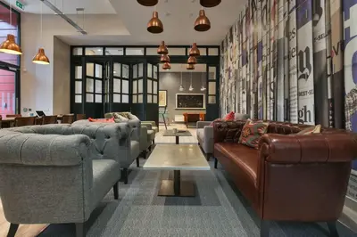 a lobby with couches and chairs and a table at For Students Only - Willowbank in Glasgow in Glasgow