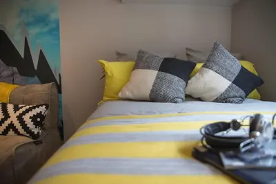 a bed with pillows on it in a room at For Students Only - Willowbank in Glasgow in Glasgow