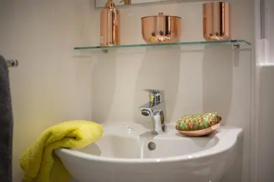 a bathroom with a sink with a yellow towel at For Students Only - Willowbank in Glasgow in Glasgow
