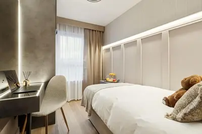 a bedroom with a bed and a sink with a teddy bear at 2BR West End Apartment Near Botanic Gardens in Glasgow