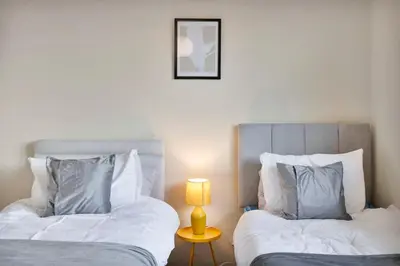 two beds sitting next to each other in a bedroom at Free Parking - Central - 2 Bedroom - 4 Guests in Livingston