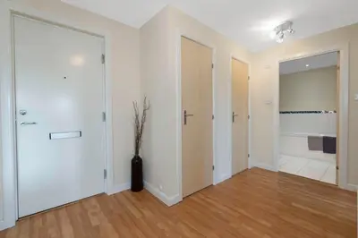 an empty room with white walls and wood floors at Free Parking - Central - 2 Bedroom - 4 Guests in Livingston
