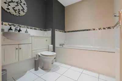 a bathroom with a sink and a toilet and a bath tub at Free Parking - Central - 2 Bedroom - 4 Guests in Livingston