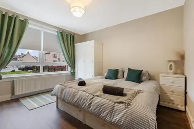 a bedroom with a large bed and a large window at Free Parking - Central - Sleeps 6 - Great Location in Armadale