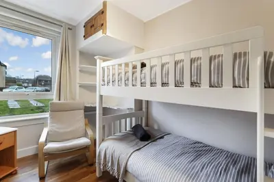 a childs bedroom with a bunk bed and a chair at Free Parking - Central - Sleeps 6 - Great Location in Armadale