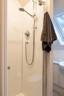 a shower with a glass door in a bathroom at 4 Bedroom Townhouse In Stirling in Stirling