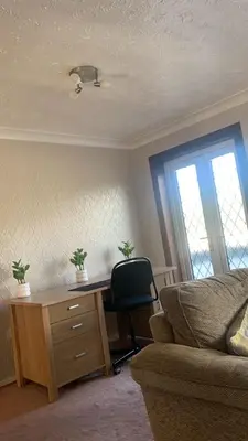 a living room with a desk and a chair at OakHouse- Entire 3 Bedroom Terrace House with Free Parking in Cumbernauld
