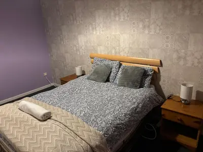 a bedroom with a bed with pillows on it at OakHouse- Entire 3 Bedroom Terrace House with Free Parking in Cumbernauld