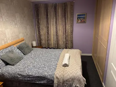 a bedroom with a bed and a window at OakHouse- Entire 3 Bedroom Terrace House with Free Parking in Cumbernauld