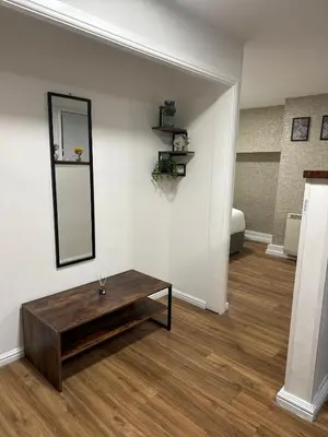 a living room with a table and a mirror at Edinburgh Rose Suites 1BHK Central EB4 in Edinburgh