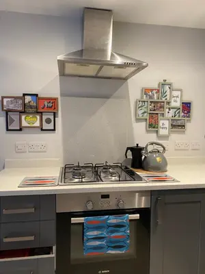a kitchen with a stove top oven in a kitchen at Coorie Cottage in Edinburgh