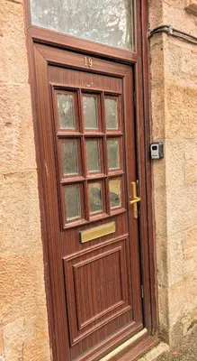 a wooden door with the number on it at Kintyre apartment in Campbeltown