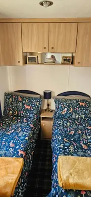 two beds sitting next to each other in a room at Montrose No3 - Turnberry Holiday Park in Turnberry