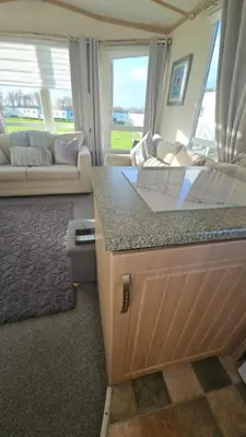 a kitchen and living room with a couch and a counter at Montrose No3 - Turnberry Holiday Park in Turnberry