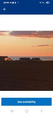 a screenshot of a cell phone screen with a sunset at Montrose No3 - Turnberry Holiday Park in Turnberry