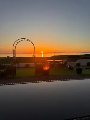 a view of a sunset from a patio with a playground at Seaview Cottage Bellochantuy