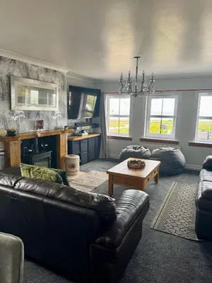 a living room with a couch and a table at Seaview Cottage Bellochantuy