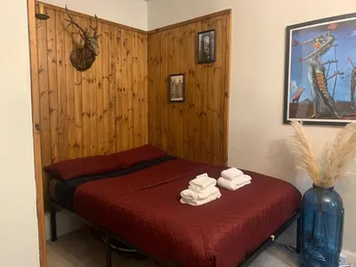 a bedroom with a bed with towels on it at Andy's Pad in Edinburgh