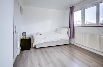 a white bedroom with a bed and a window at Southend perfect Stays in Moffat