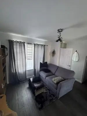 a living room with a couch and a chair at Private Room in Berkhamsted high street in Moffat