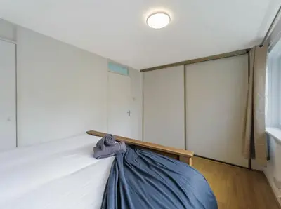 a bedroom with a bed with a blue blanket on it at Free Parking - 3 Bedrooms - Sleeps 7 - Airport in Paisley