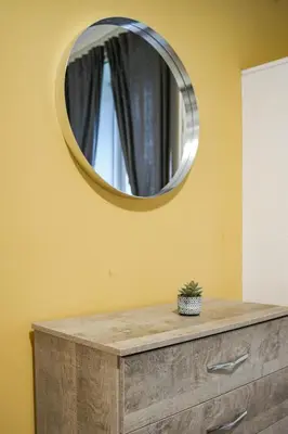 a mirror on the wall above a dresser at Neilston Gateaway in Paisley